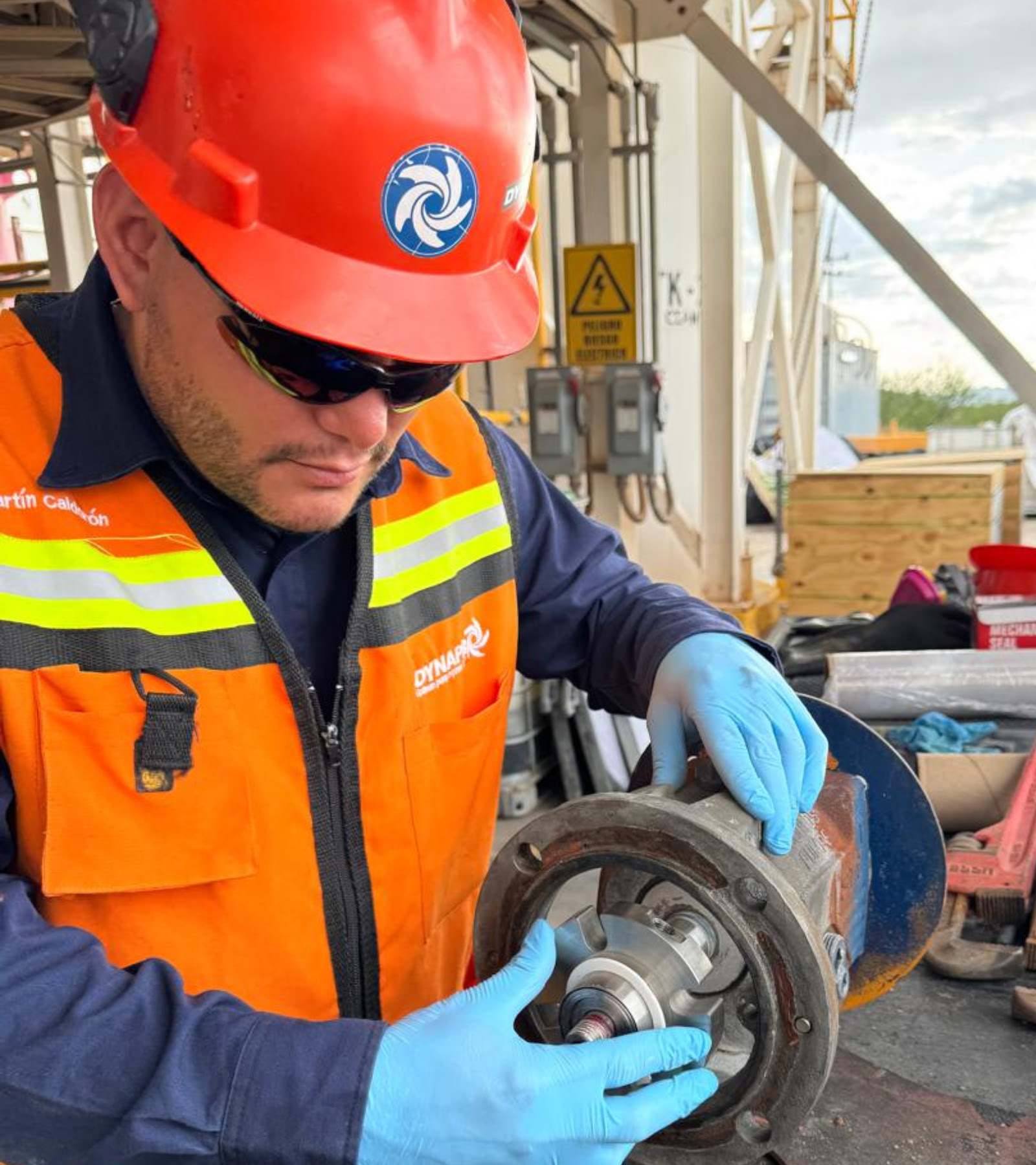 Dynapro technician inspecting a submersible pump mechanical seal during maintenance.